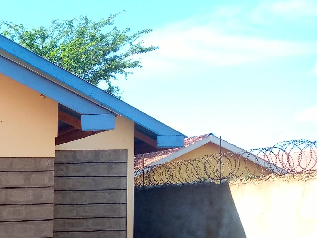 The compound wall topped with razor wire