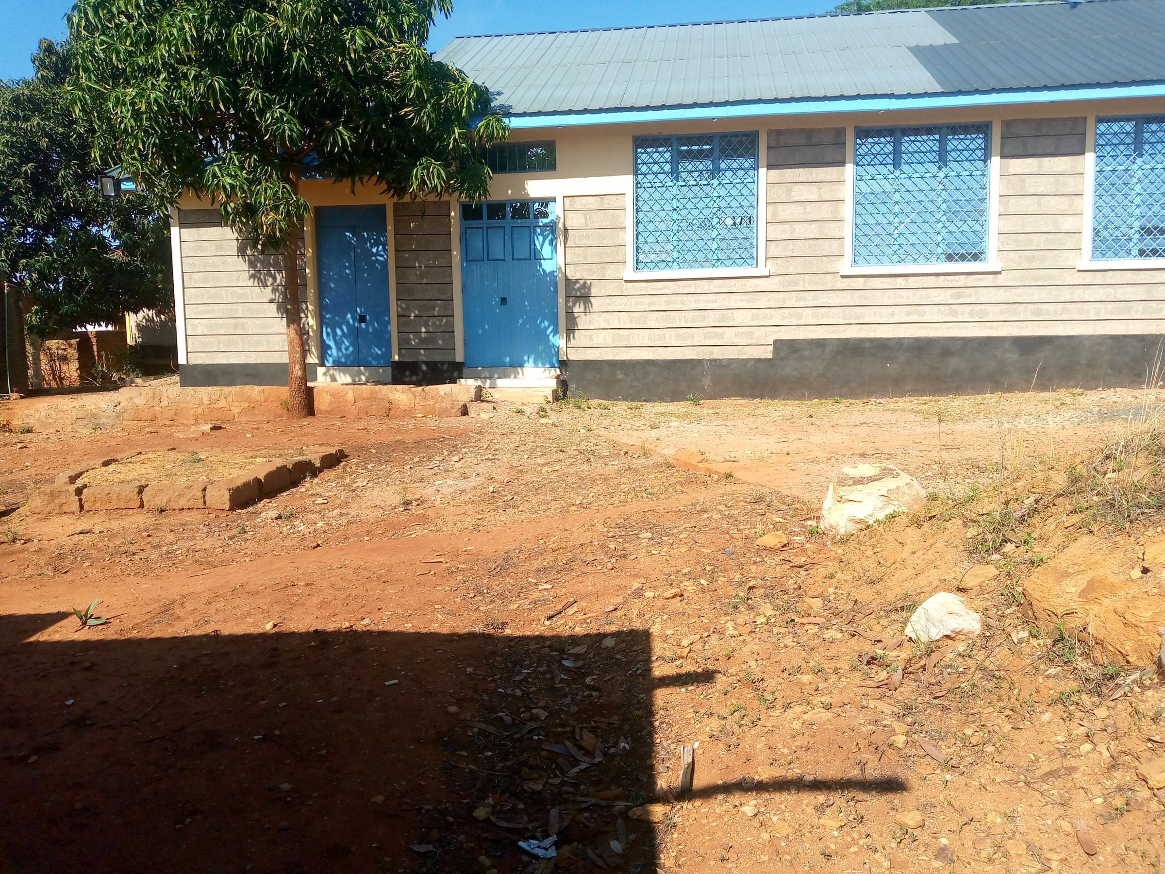 Side doors and a shade tree in the compound
