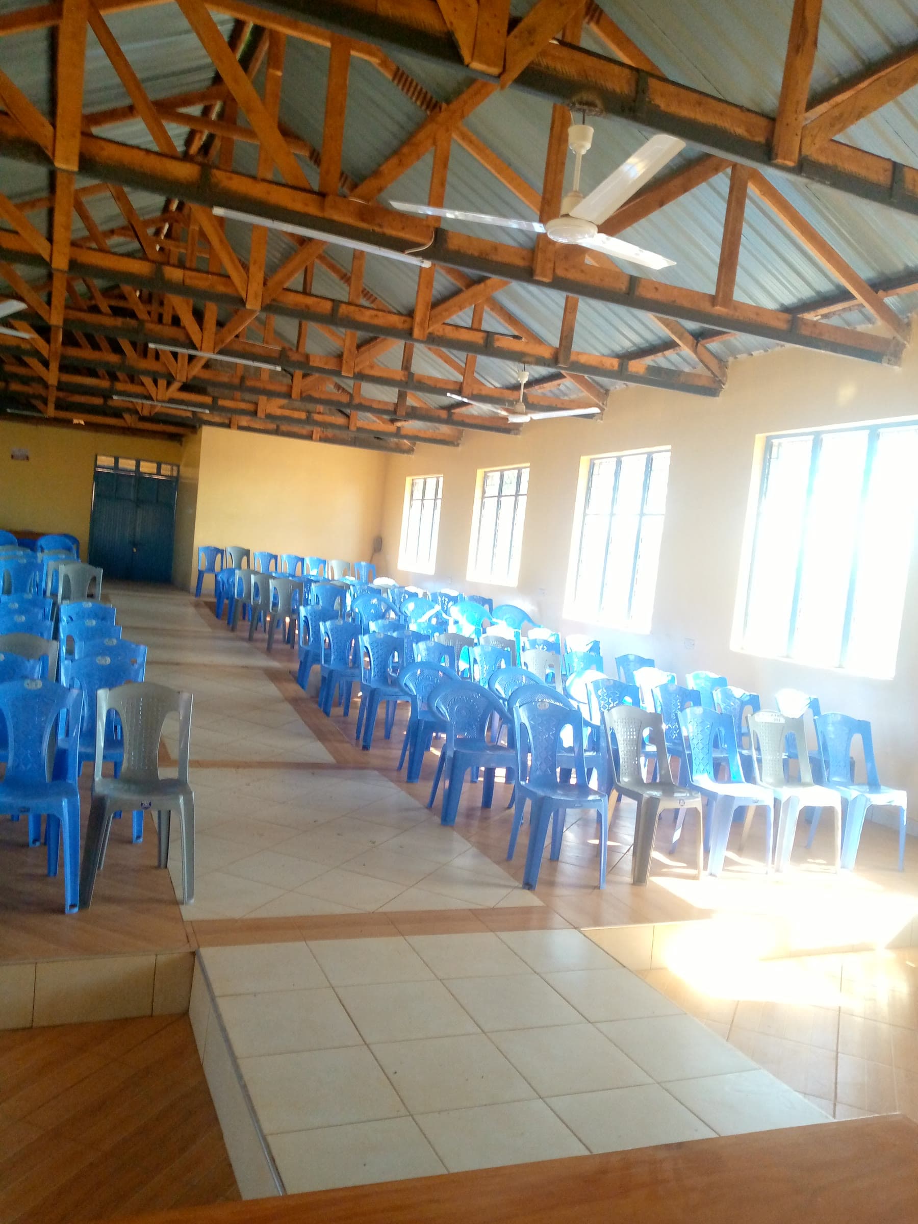 Rows of chairs facing the platform under the timber roof